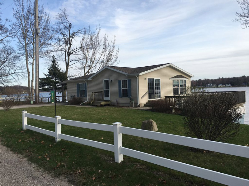 A house with a white fence and some trees