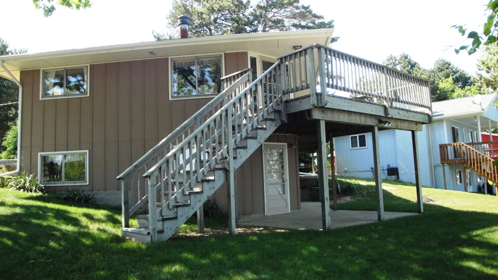 A house with stairs going up the side of it.