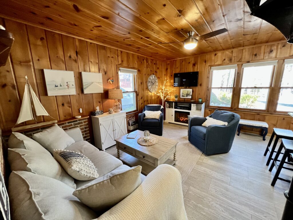 A living room with wood paneled walls and floors.